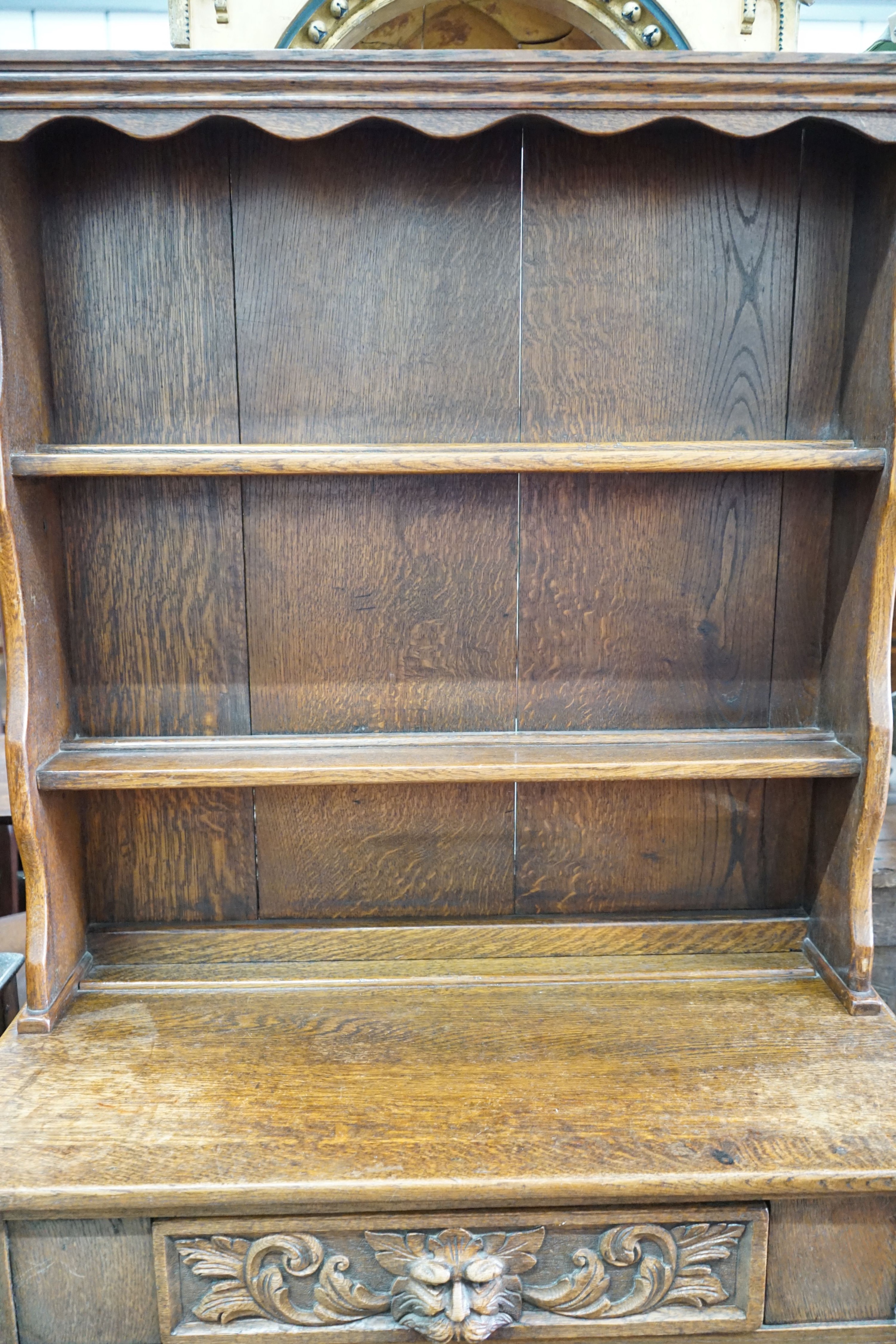 An early 20th century Flemish carved oak dresser, width 91cm, depth 40cm, height 177cm